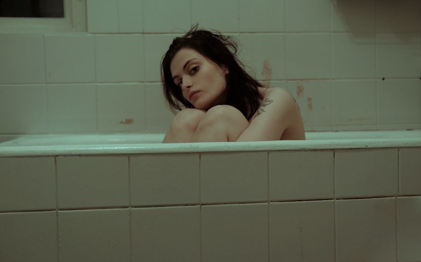 Portrait of young woman in bathtub