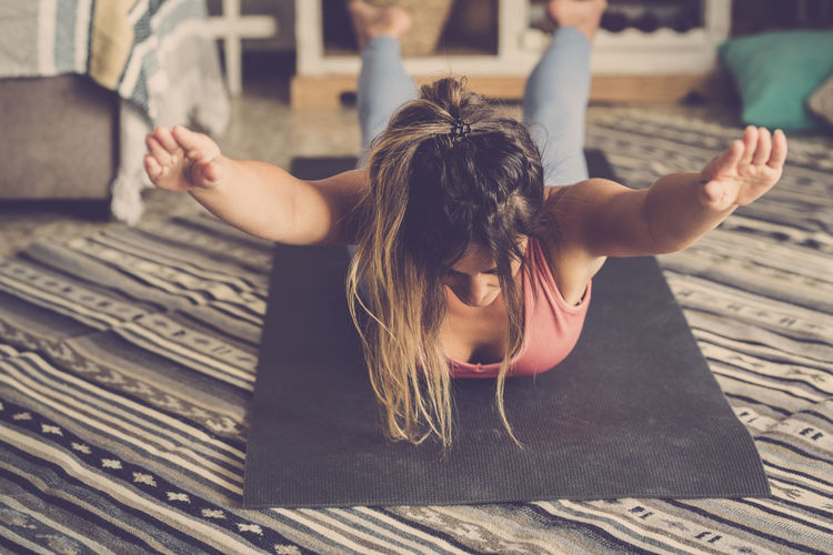Woman exercising on floor while lying down