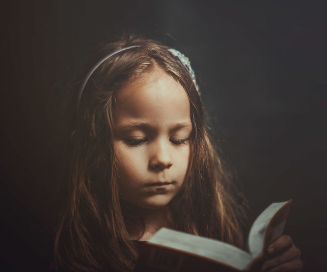 Portrait of girl reading book