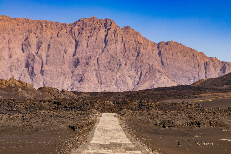 Lava from the last eruption of pico do fogo buries the narrow road, fogo island, cape verde islands