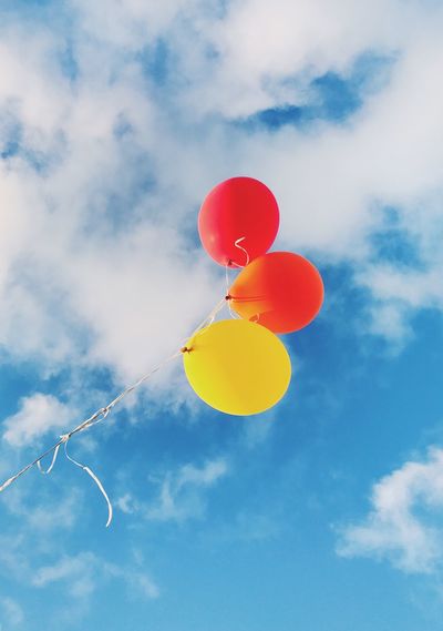 Low angle view of balloons against sky