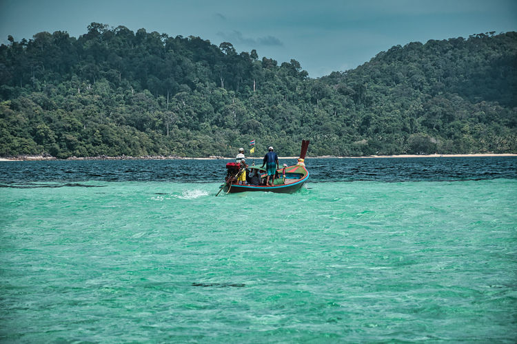 People kayaking in sea