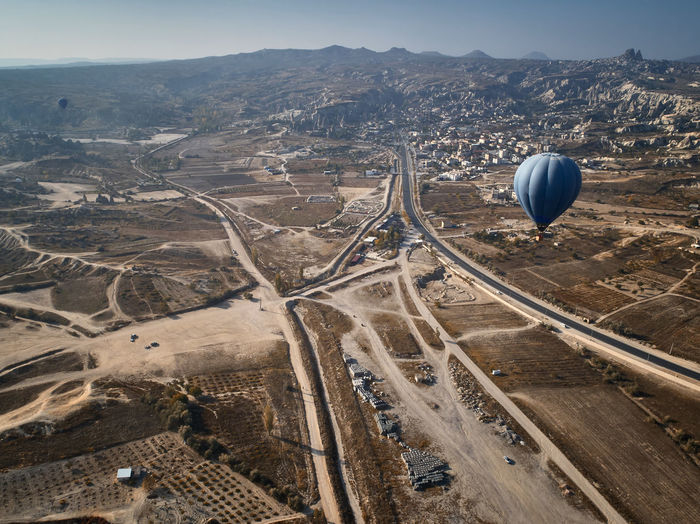 Colorful hot air balloons in the sunny goreme national park, cappadocia, turkey. aerial view