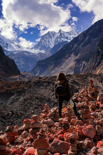 Woman standing on landscape against mountains