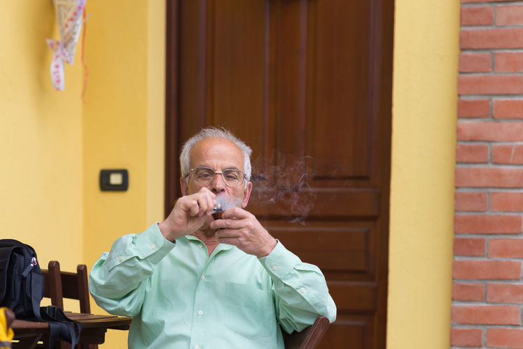Portrait of man smoking pipe