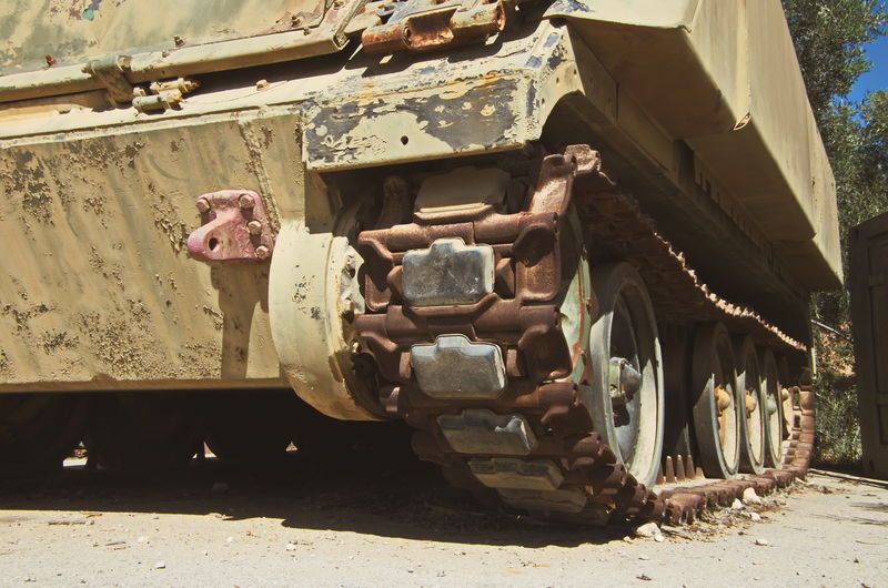 Rusty armored tank on road