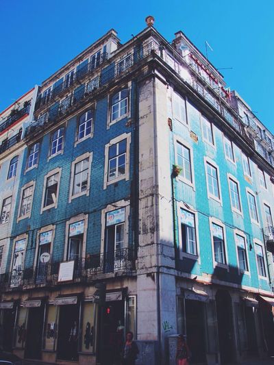 Low angle view of building against blue sky