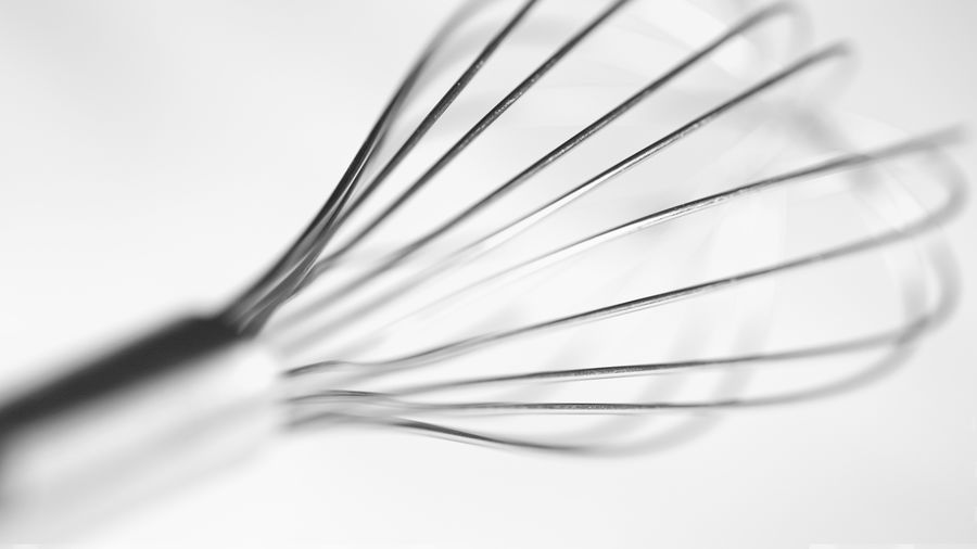 Close-up of wire whisk against white background