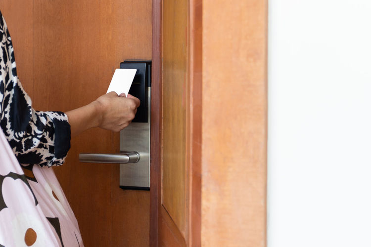 Woman's open hotel room with electronic key card.