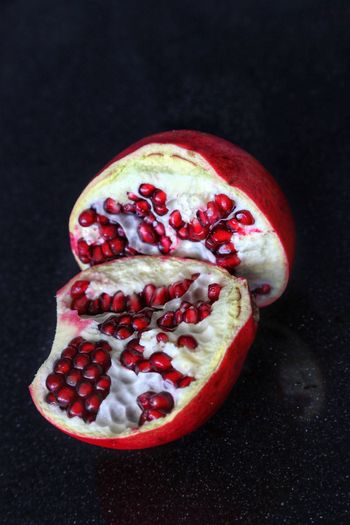 Close-up of pomegranate against black background