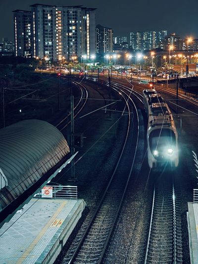 City lights shines on the erl train arriving at the bandar tasek selatan transit station near tbs