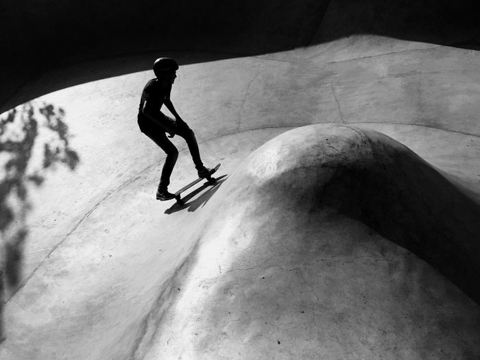 Full length of silhouette man skateboarding in park